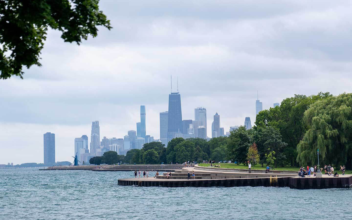 A photo from a beach near Lakeview showing trees in a park with the skyline far behind the park