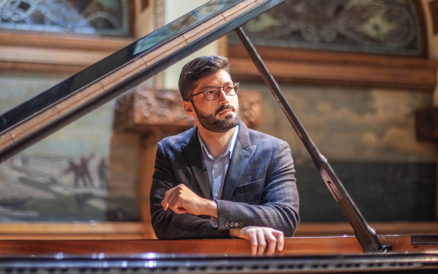 Roosevelt alum Elider DiPaula, seated at the piano in Ganz Hall.