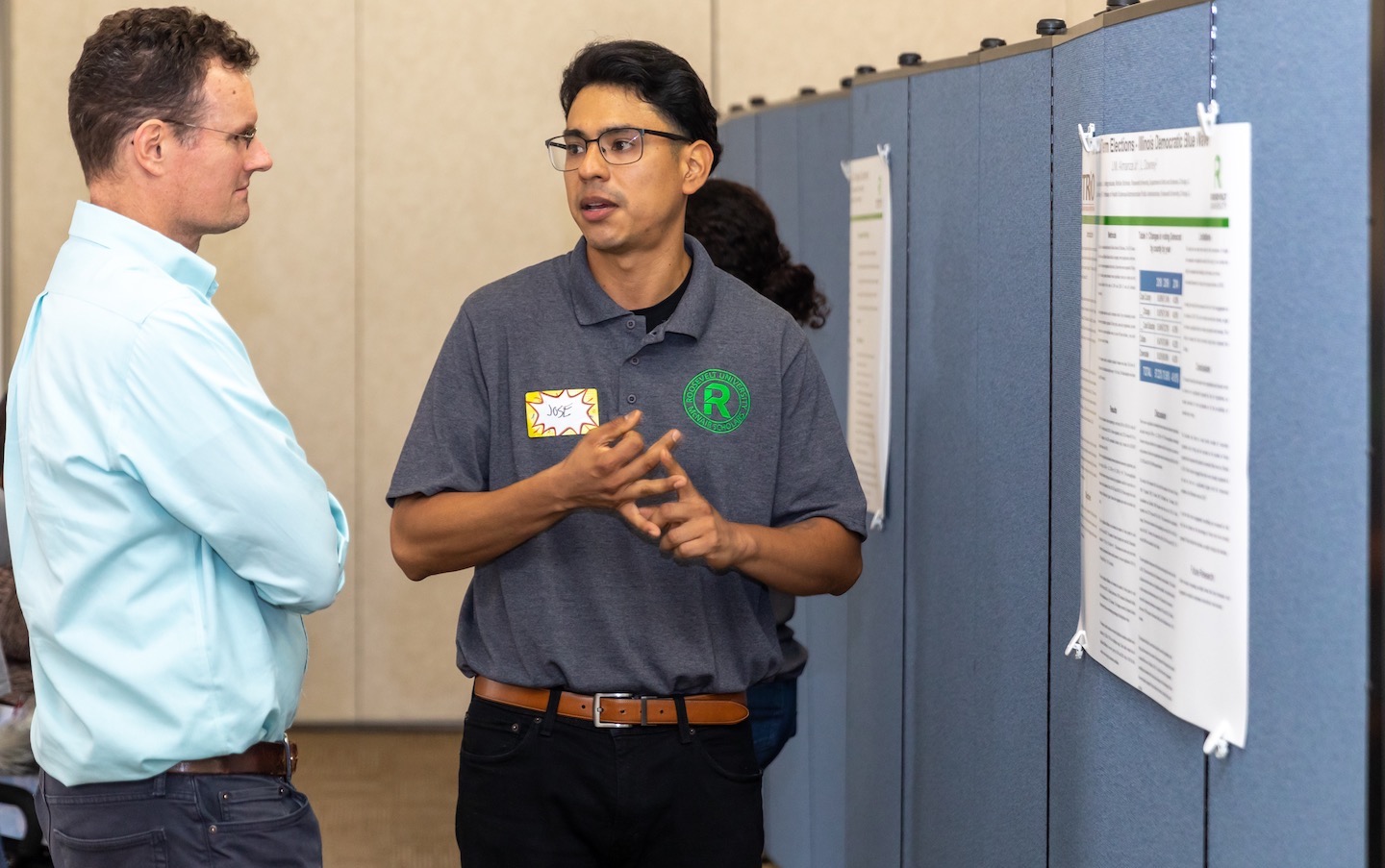 Political science student Jose Almanza (right) presenting his research as a McNair Scholar.