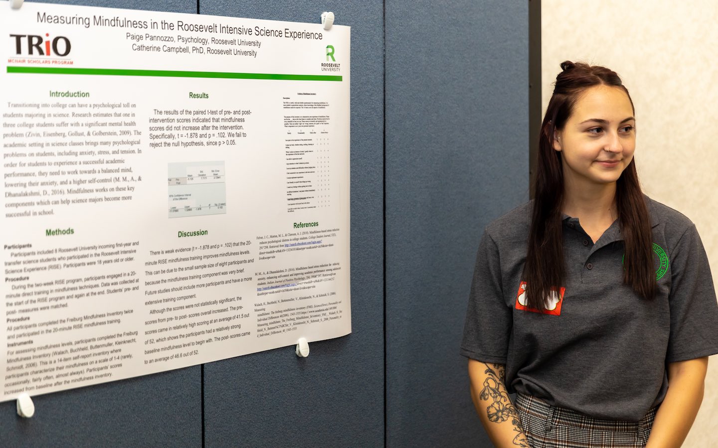 McNair Scholar Paige Pannozzo stands in front of her research poster