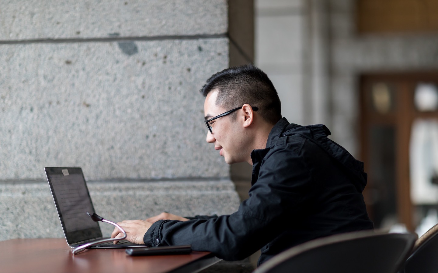Roosevelt student types on his laptop