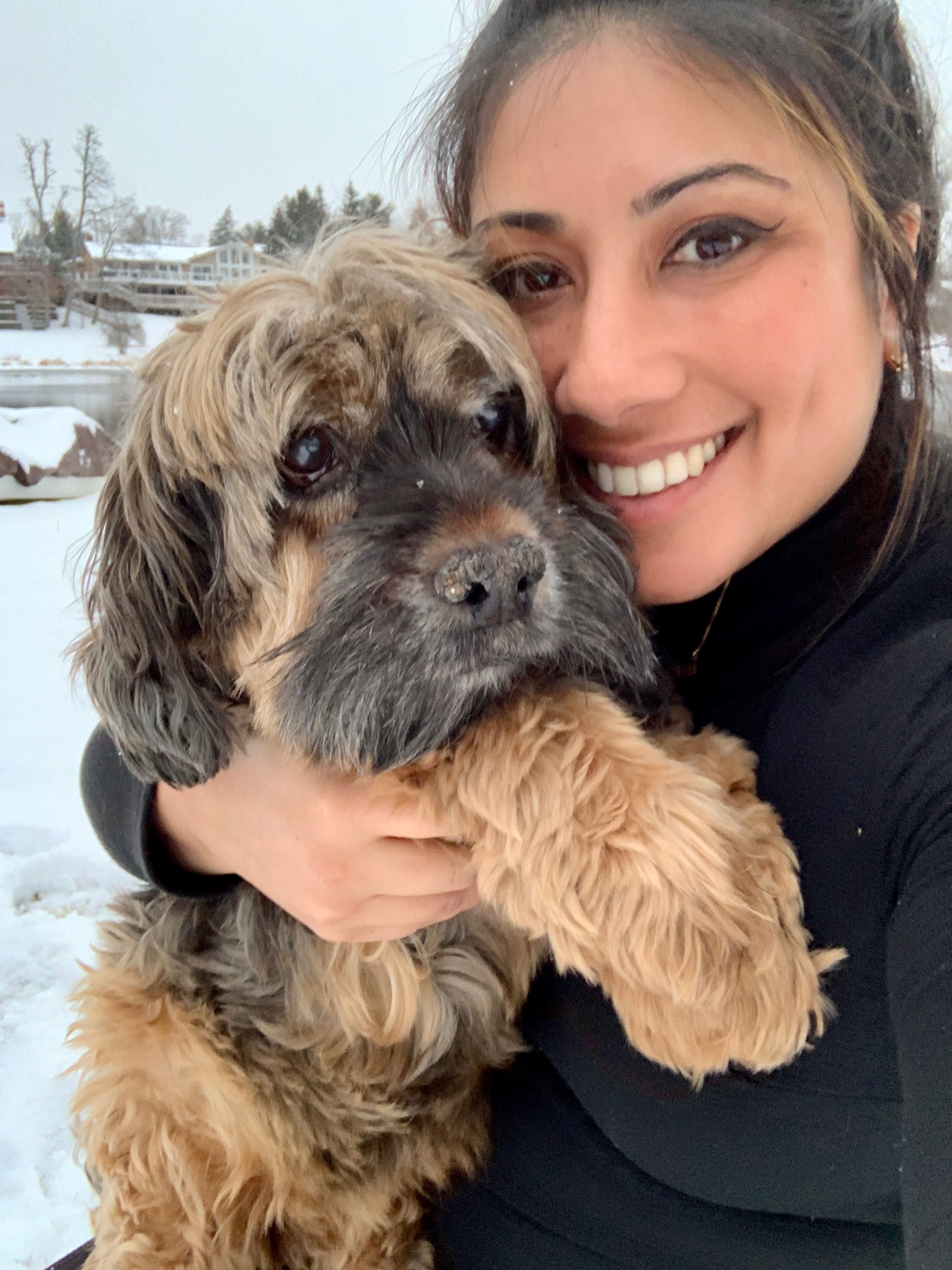 Preclinical Pyschology Certificate student, Sabina Bhasin holding a brown puppy dog.