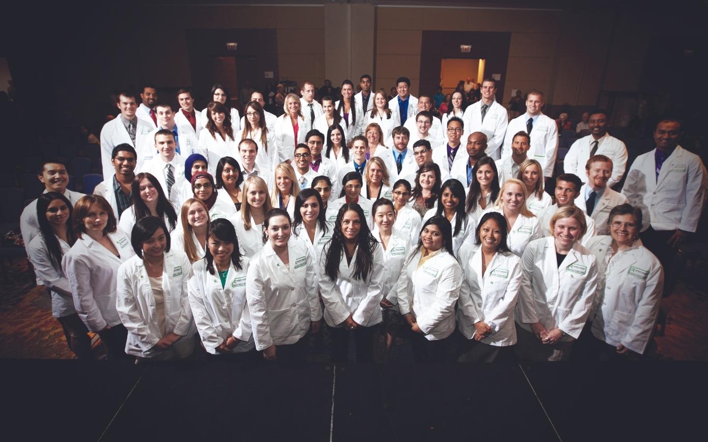 Group photo of pharmacy students in white coat