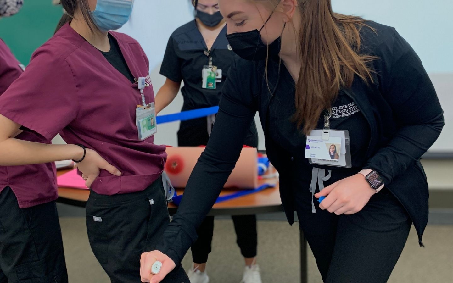 Nursing students learn how to administer a shot
