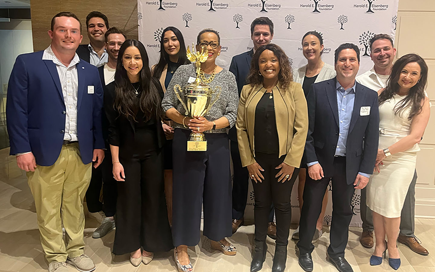 Roosevelt students and faculty, holding the trophy from the Eisenberg Annual Challenge