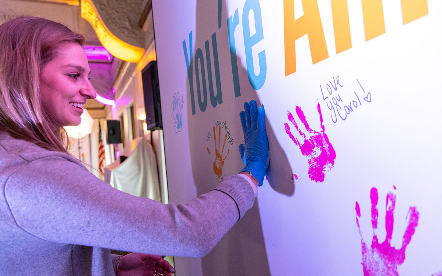 Roosevelt student leaves a paint handprint on Perfect Memorial art display.