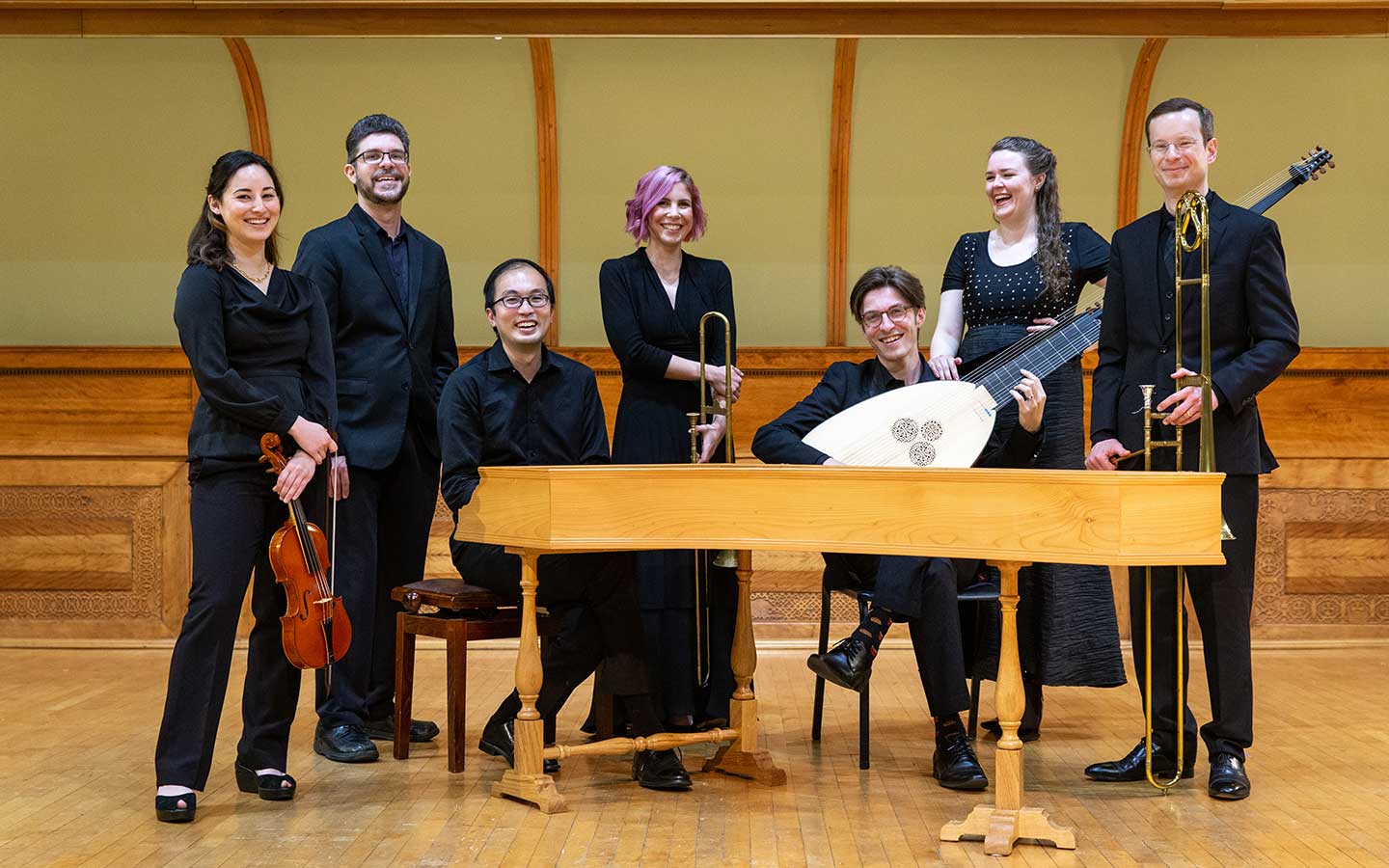 the members of Newberry Consort stand around a piano