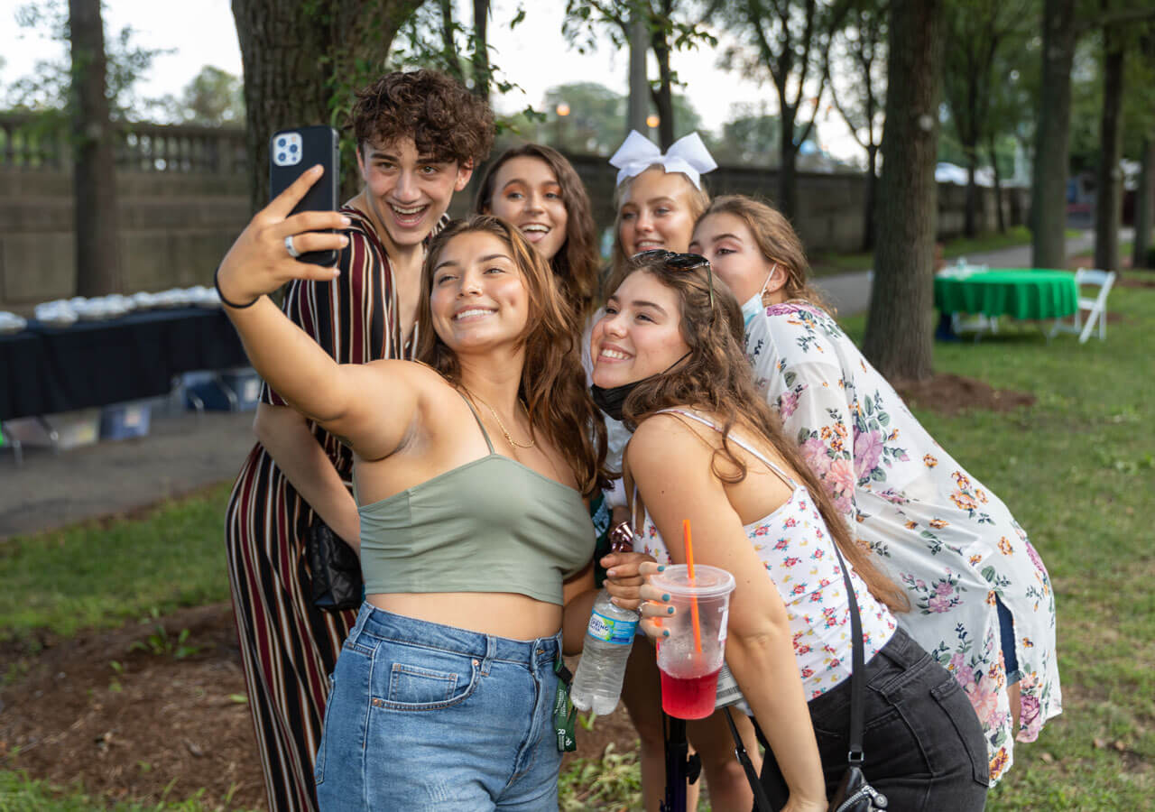 A small group of students posing for a group selfie