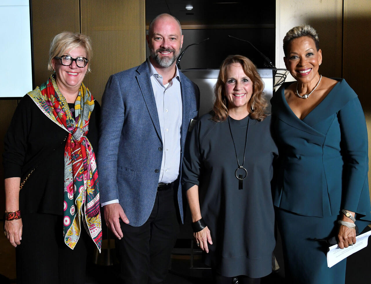 Co-chairs and gala honoree posing for a photo during the 2022 Marshall Bennett Real Estate Institute Gala