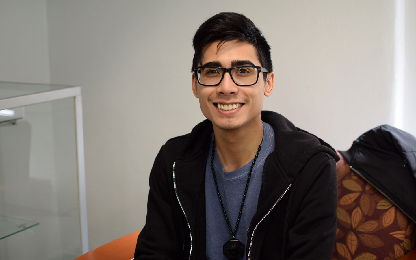 Student wearing glasses and smiling