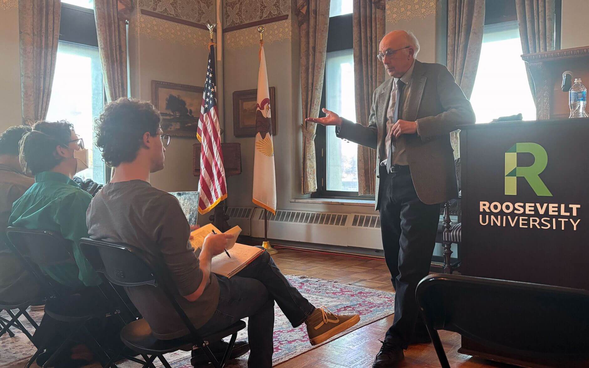 Dr. John Wenke lecturing in front of an audience