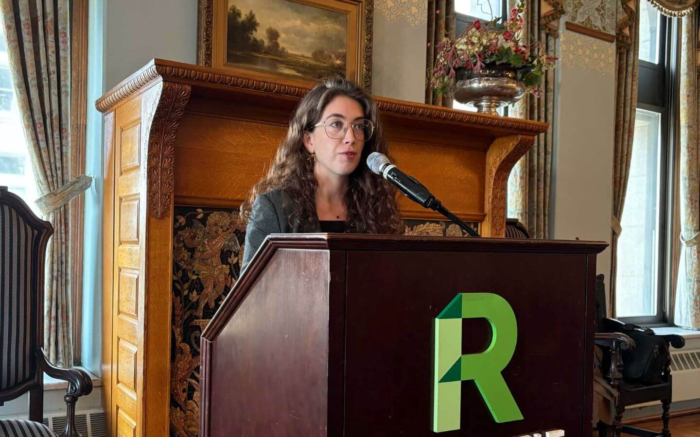 Women standing in front of a podium with a microphone.