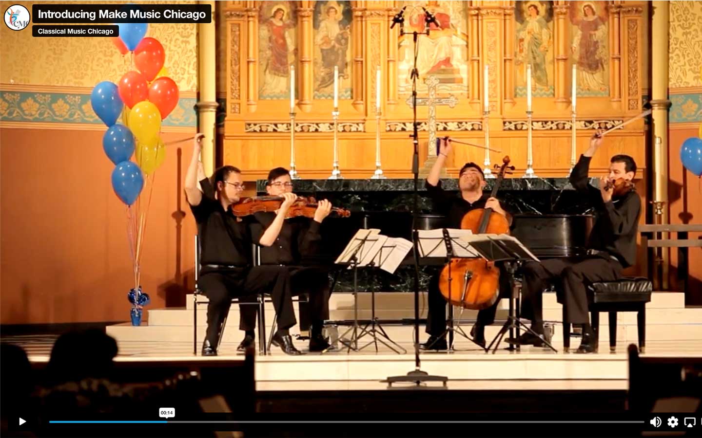 Still from the "Introducing Make Music Chicago" video showing a string quartet on a stage, surrounded by balloons