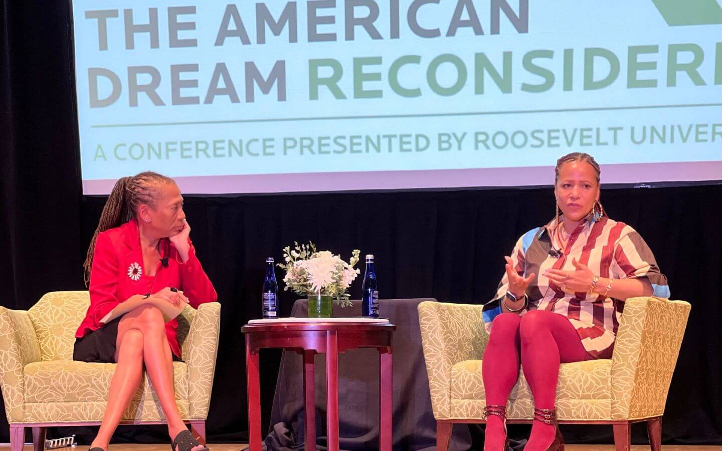 Moderator, Laura Washington, sitting in chair listening to Nikole Hannah-Jones also sitting on stage at the 2026 Roosevelt University American Dream Reconsidered Conference 