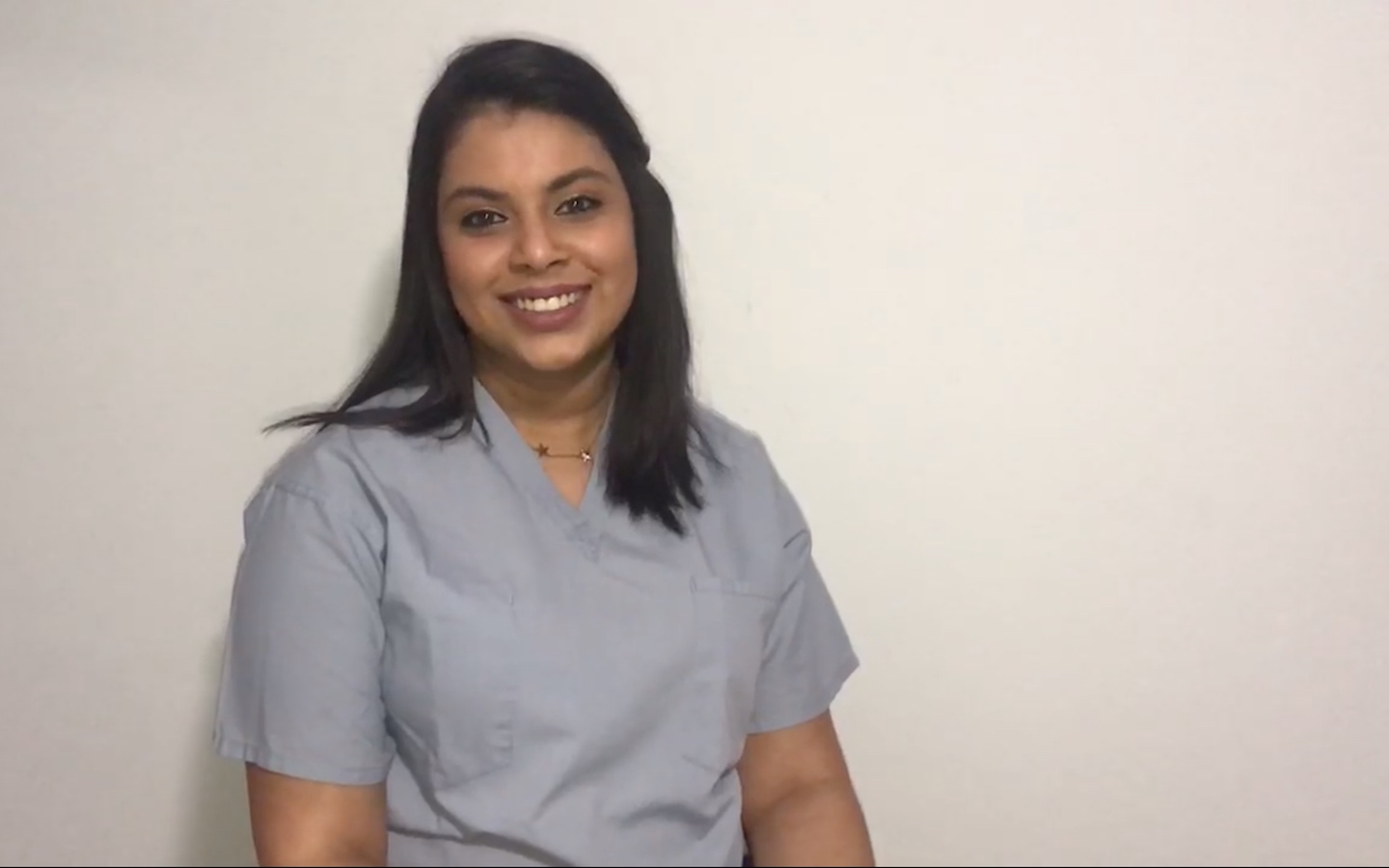 Robert Morris alum and ER nurse Pooja Shah, wearing scrubs