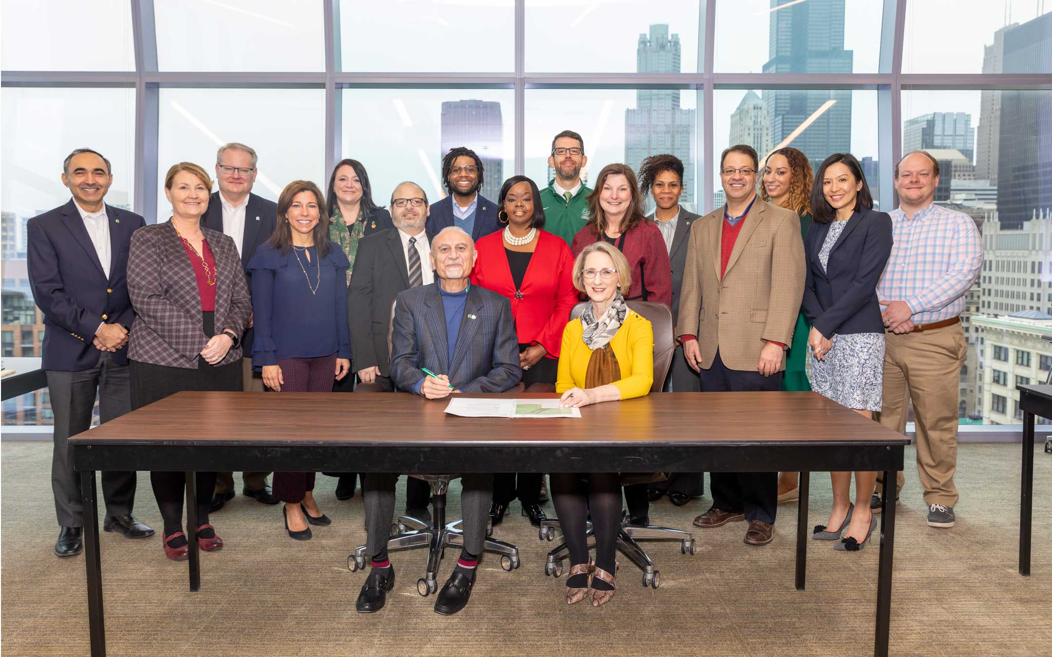 Integration steering committee looks on while RU and RMU presidents sign an agreement