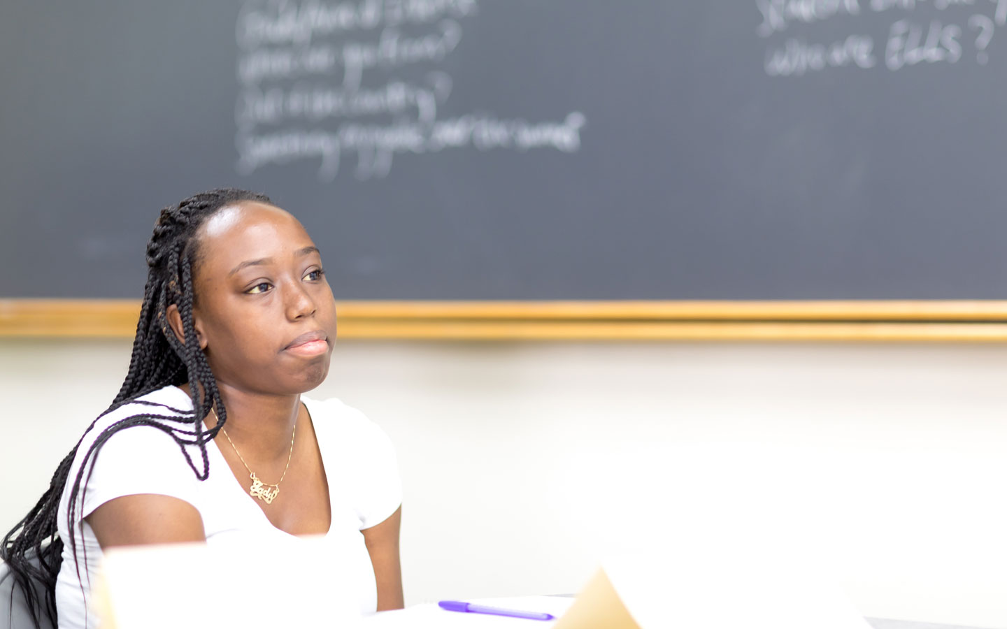 Student in front of blackboard