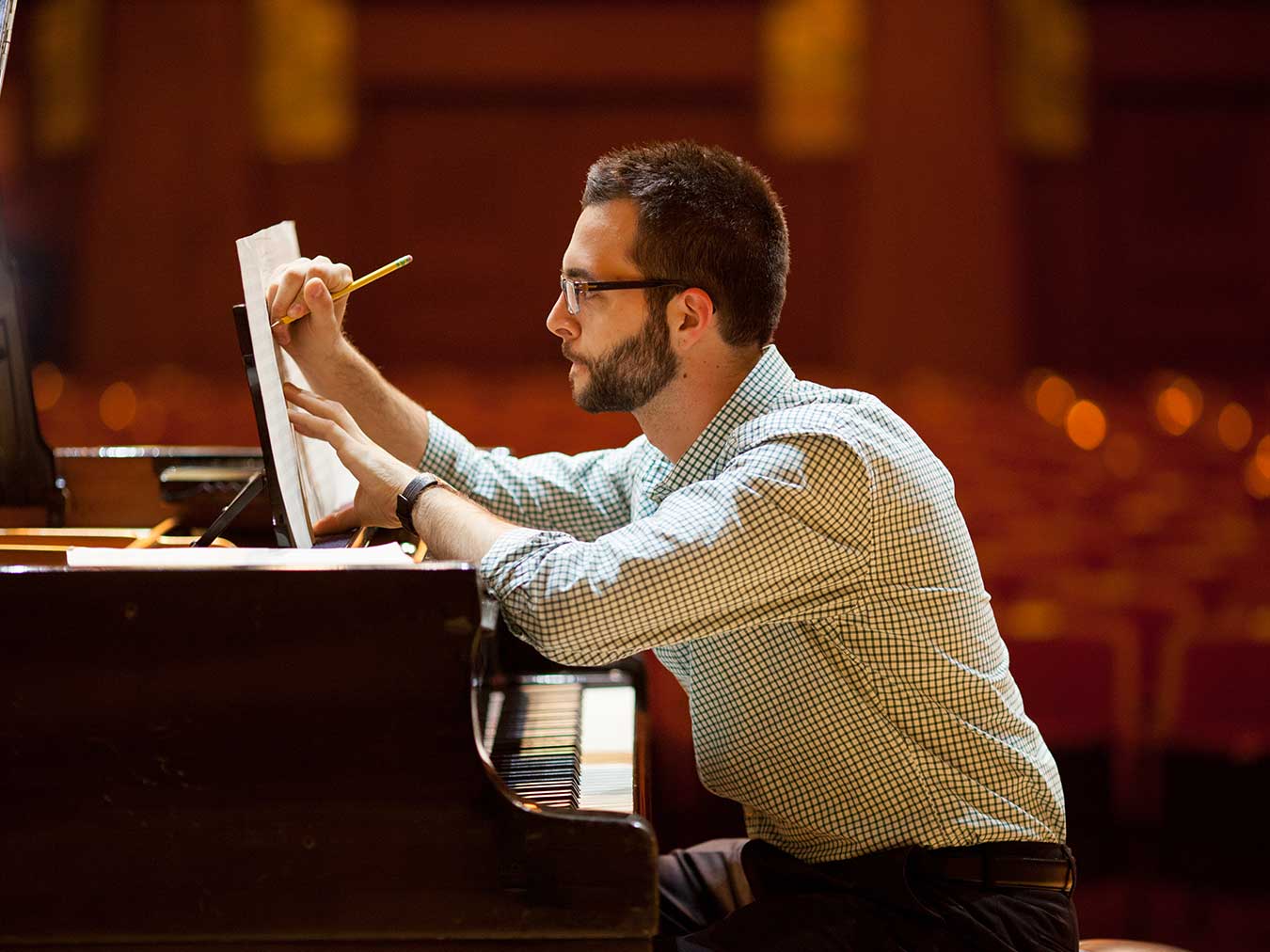 Roosevelt student composing at piano in Ganz Hall