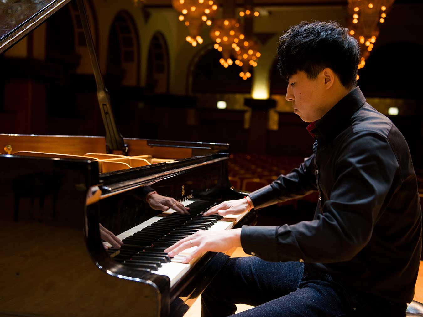 student rehearsing at piano