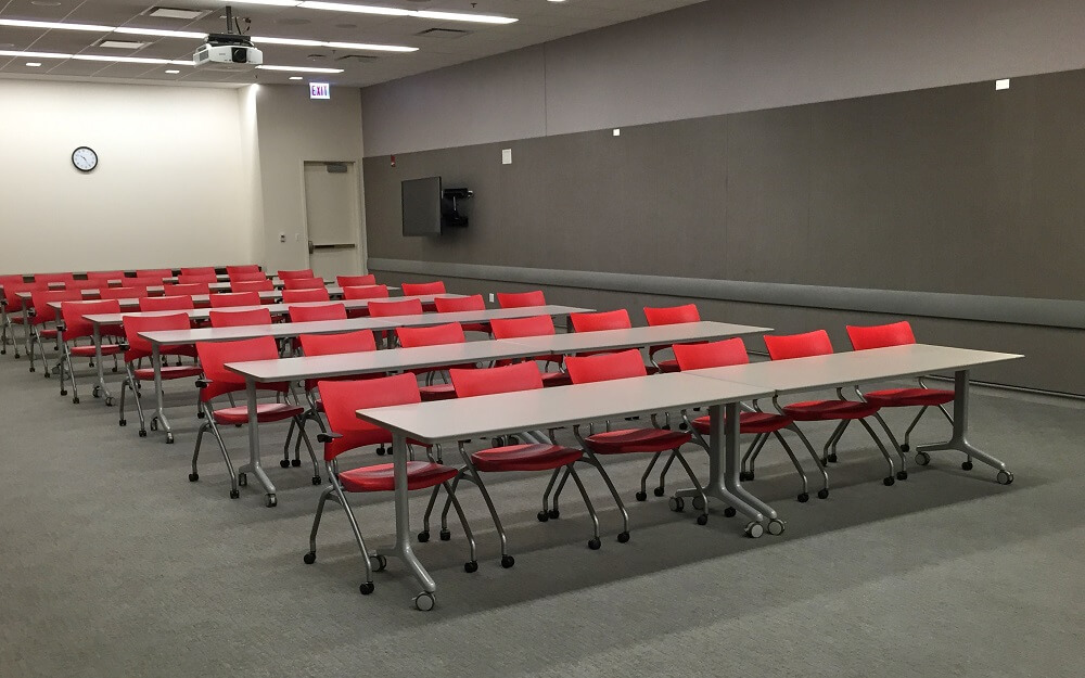 Large open space with rows of tables and chairs