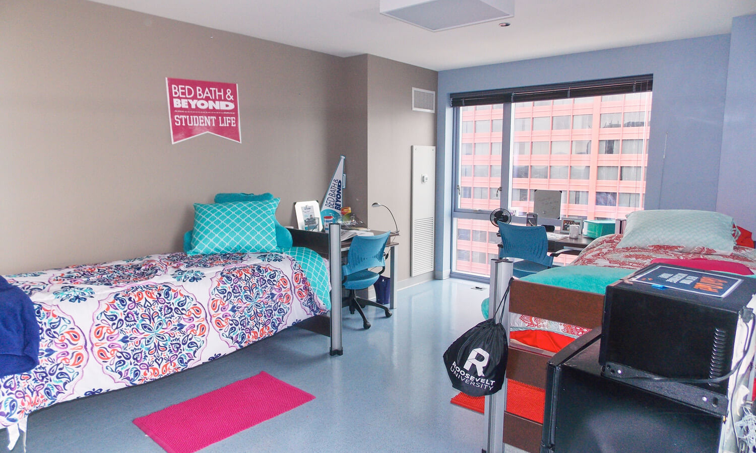 View of a double-occupancy dorm room with two beds and two desks.