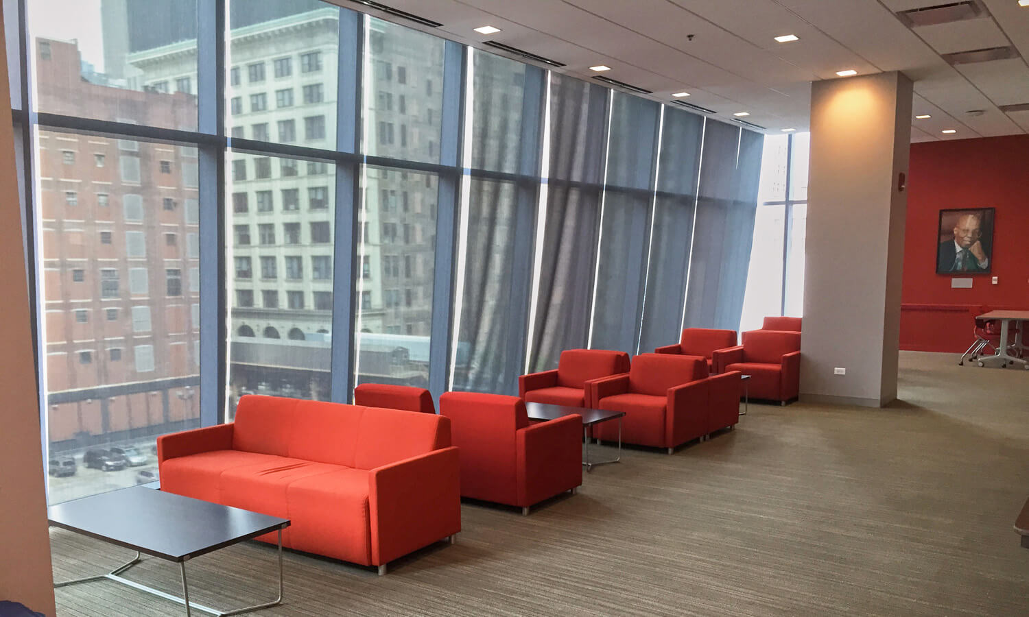 Lounge or reception space with orange couches and glass tables