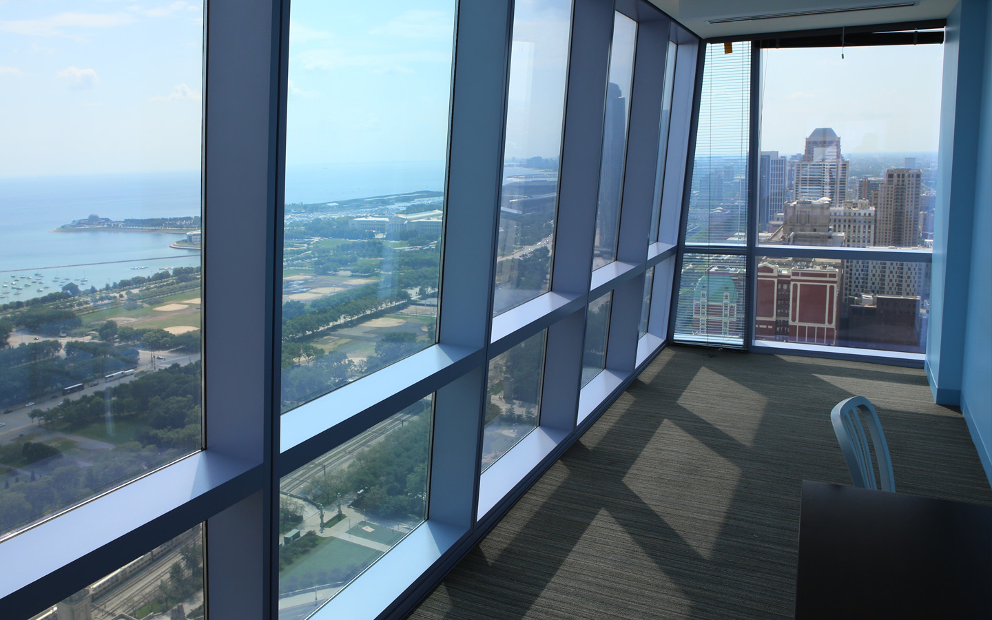 A panoramic skyline view of Chicago from one of the Wabash Building’s suite residences featuring the floor to ceiling windows.