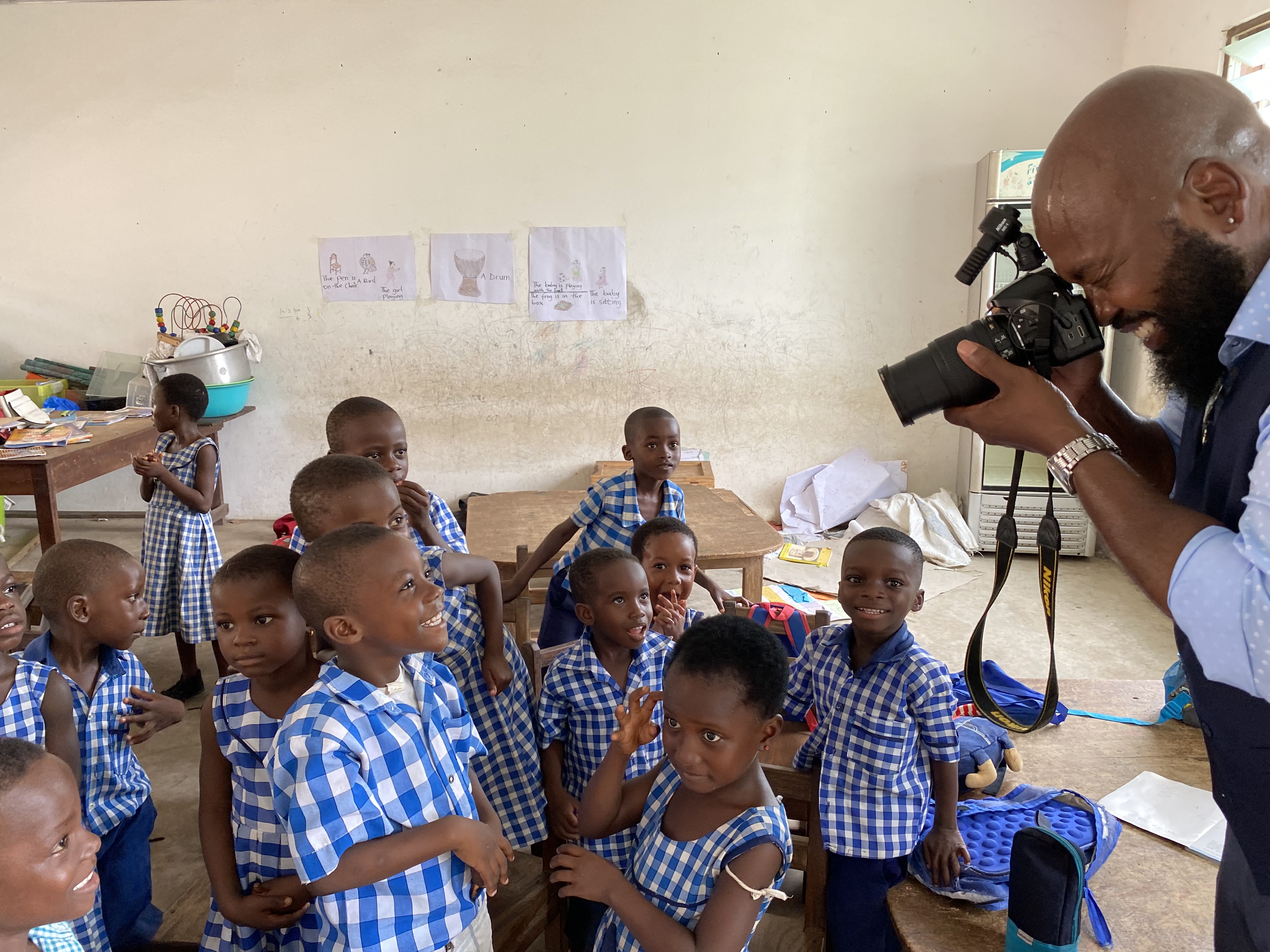 Professor Fountain photographs children at an orphanage in Ghana, where he was a 2021-22 Fulbright Scholar.