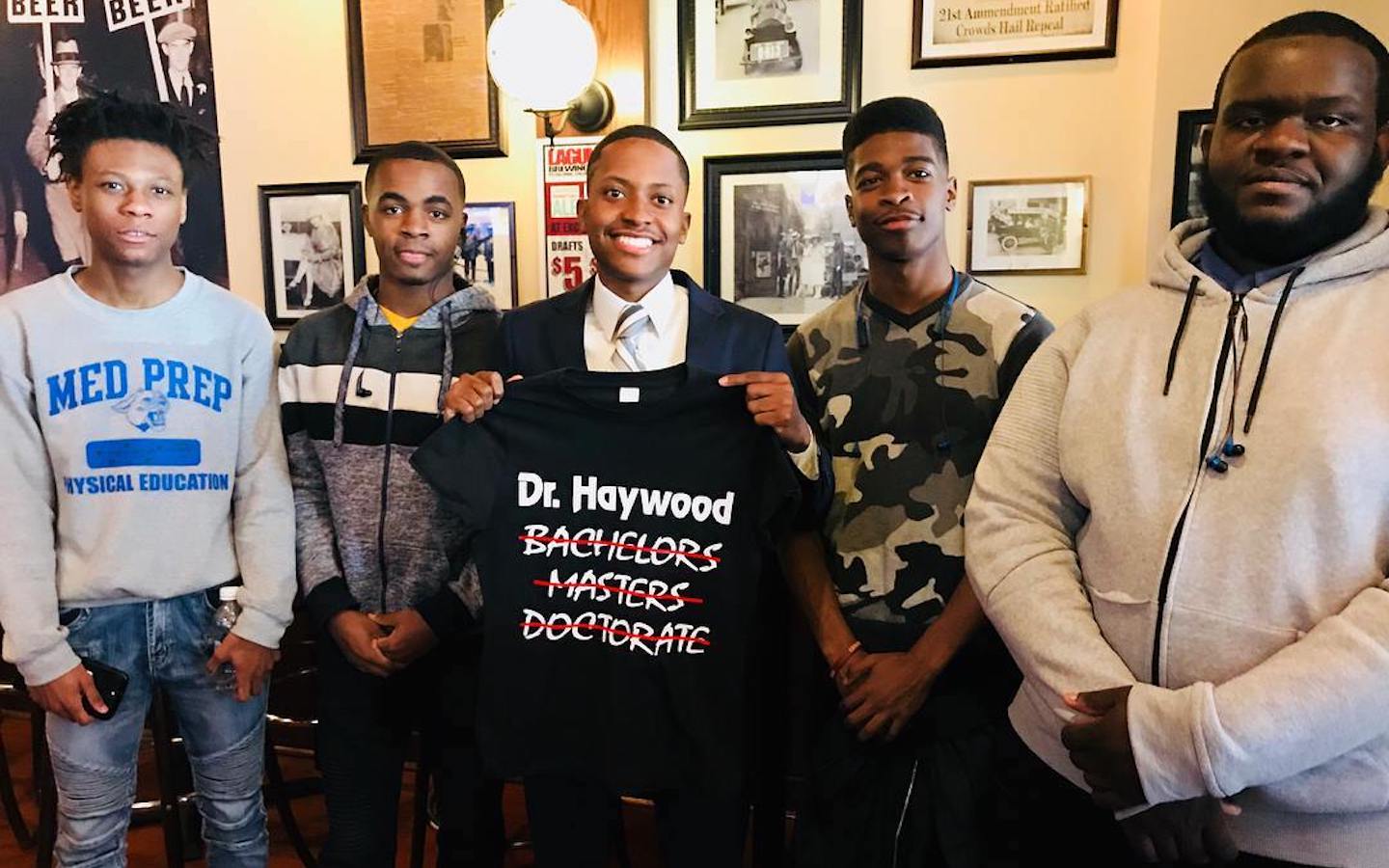 Roosevelt University alum Marlon Haywood (center) with four mentees after his dissertation defense. 