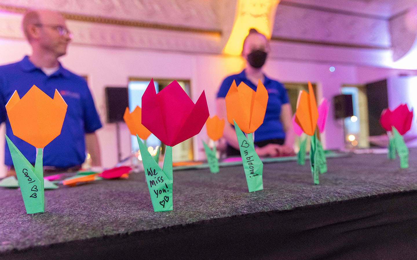 Attendees left messages on folded flowers during Dr. Carol Brown's memorial.