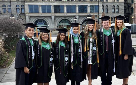 Group of BSN Nursing Students Celebrate Graduation outside of Roosevelts Auditorium Building