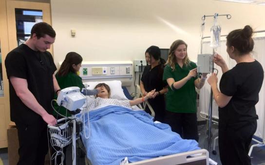 Diverse group of nursing students practicing in the labs