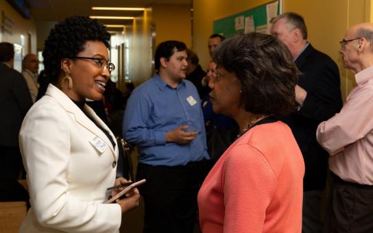 Female MBA student networking with professor