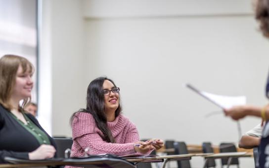 Two students participate in a class lecture