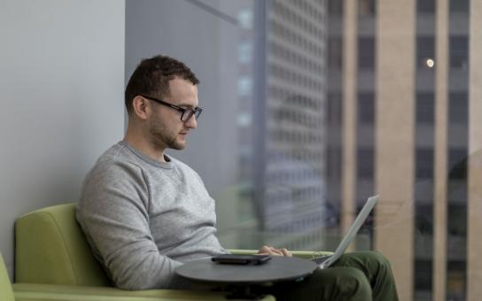 Male student working on laptop