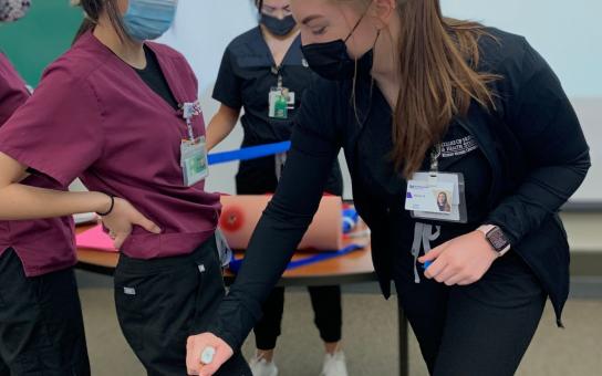 Nursing students learn how to administer a shot