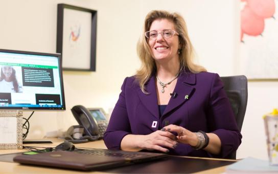 Faculty member Debra Orr meets with students