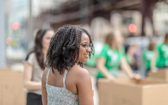 Roosevelt student stands on the Wabash sidewalk on move-in day