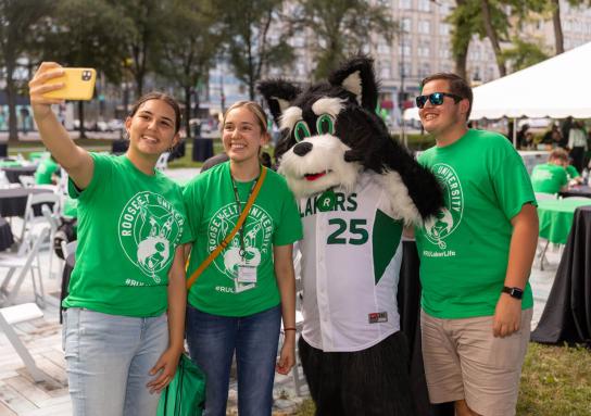 Students posing for a selfie photo with Fala the RU mascot