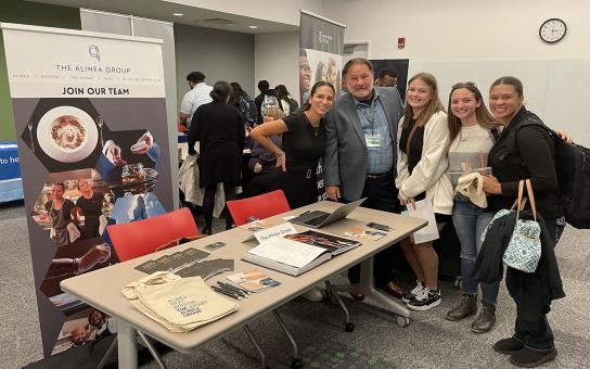 Student posing for a photo with an employer at a career services event.