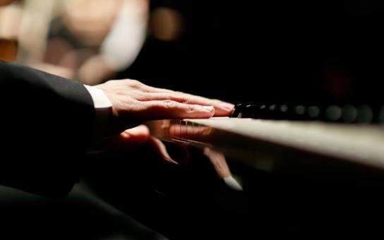 Close-up of hands on piano keys