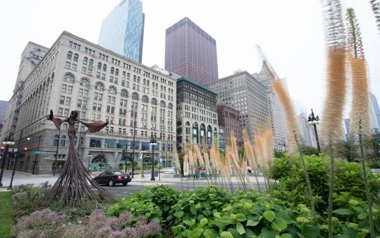 Garden and statue in the foreground with Auditorium and Wabash building in the background