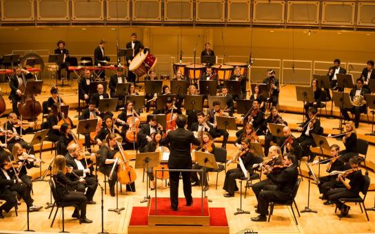 Symphony orchestra performing in a concert hall
