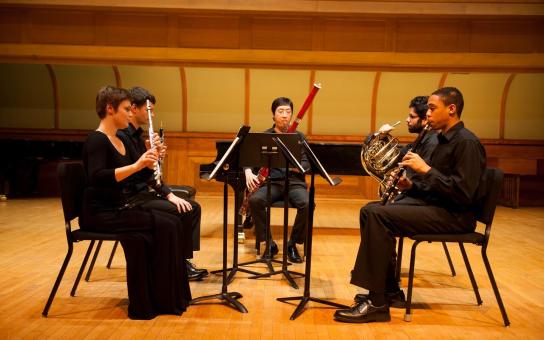 Quartet of woodwind instruments performing on stage
