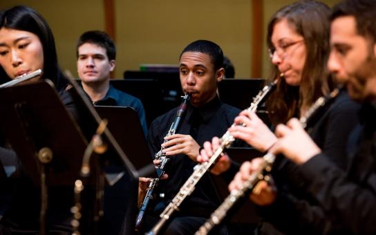 Oboist performing in an ensemble