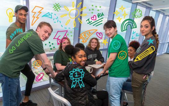 group of students gathered around a table, with insporational doodles around them