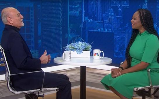 President Ali Malekzadeh sitting at table with a interviewer discussing Roosevelt's History and 80th Anniversary Event on NBC 5 Chicago Making a Difference Segment about 80th Anniversary.