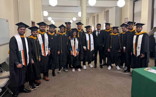 A group of international students in graduation caps and gowns