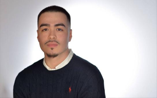 McNair Scholar, Honors CCPA Student and MBA candidate Helder Perez-Viera wearing a dark colored shirt on a plain white background.