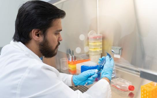 Science or Pharmarcy student examining a tool in lab
